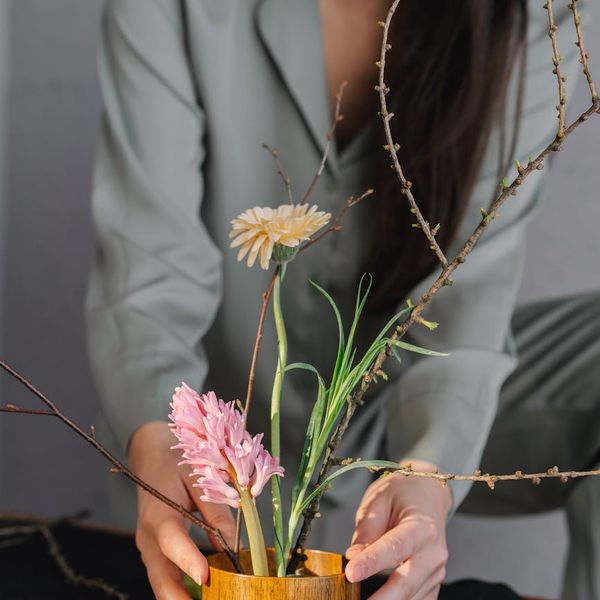 Person meditating peacefully in a room with soft, natural light.